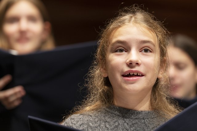Mädchen singt im Chor.